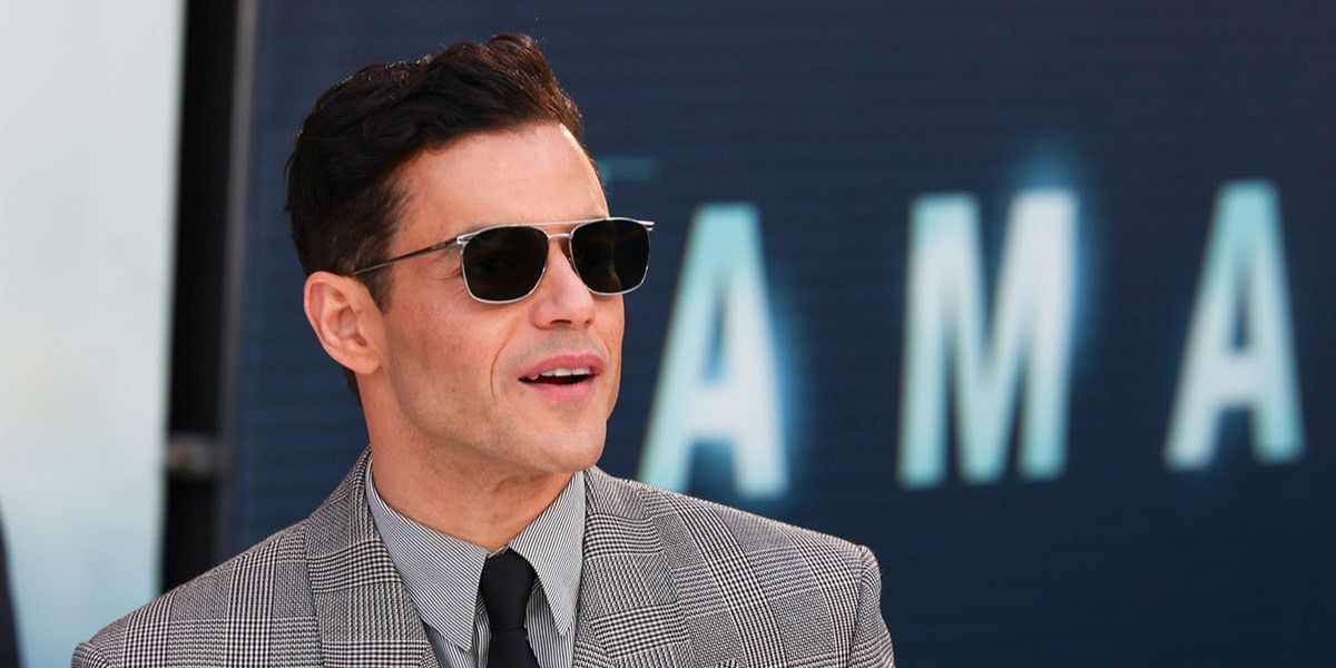 Rami Malek was seen wearing silver Saint Laurent SL 796 Vincent 002 square sunglasses with grey lenses at the London premiere of "The Amateur", April 2025