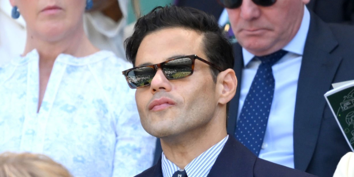 Rami Malek was seen wearing tortoiseshell Saint Laurent Sun SL 890 Betty Thin 003 sunglasses with grey lenses at the Wimbledon Tennis Championship Final 2026