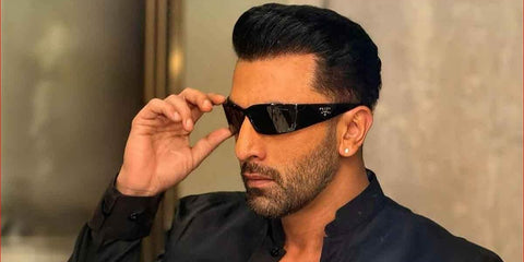 Bollywood actor Ranbir Kapoor was seen wearing black Prada PR A19S 1AB5S0 wraparound sunglasses