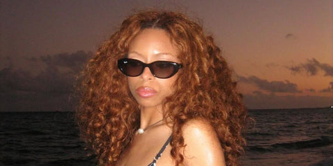 Singer-songwriter Ravyn Lenae was seen wearing black Ray-Ban RB 4457D 6677/87 sunglasses in her Instagram post, December 2025.