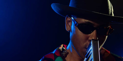 Singer-songwriter Reuben James was seen wearing tortoiseshell Prada PR 26ZS 17N60B sunglasses with light brown lenses in Jassmine Warsaw jazz club's Instagram post, November 2025