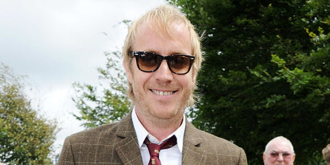 Actor Rhys Ifans was seen wearing black and transparent Ray-Ban Wayfarer RB 2140 1294/33 sunglasses with brown lenses