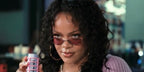 Rihanna was seen wearing gunmetal Ray-Ban Kai RB 3757 004/69 oval sunglasses with purple pink lenses in Fenty Skin's "DON'T BE DUMB. USE SPF" campaign, released July 2026.