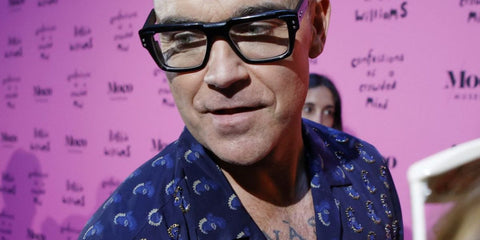 Robbie Williams is seen wearing Dita Detron DTX 459 02 optical glasses to his solo exhibition 'Confessions of A Crowded Mind' in Barcelona