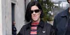 Singer-songwriter Romy Madley Croft of The xx was seen wearing black Prada PR B06S 16K08Z sunglasses at the Prada Spring/Summer 2026 fashion show during Milan Fashion Week