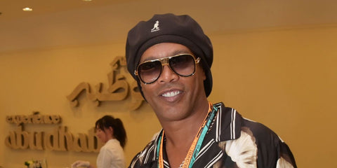 Ronaldinho was seen wearing black and gold Dita Grand Decade DTS 460 01 30th Anniversary Limited Edition sunglasses at the F1 Grand Prix of Abu Dhabi 2025.