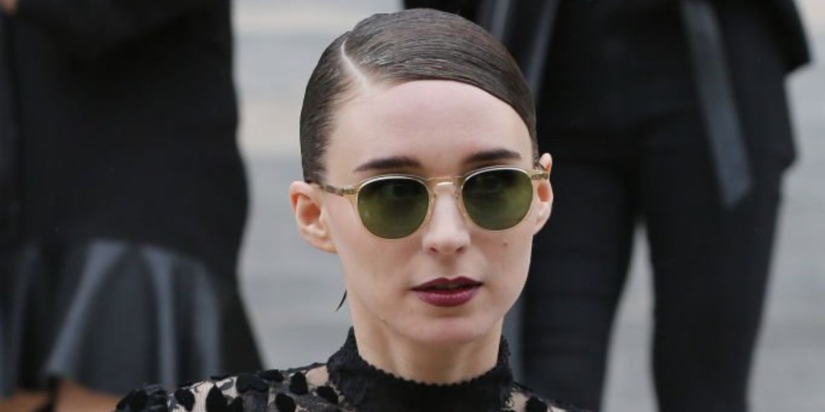 Rooney Mara was seen wearing transparent Garrett Leight Hampton X 2082 PG/PGN sunglasses with green lenses to attend the Givenchy show during Paris Fashion Week