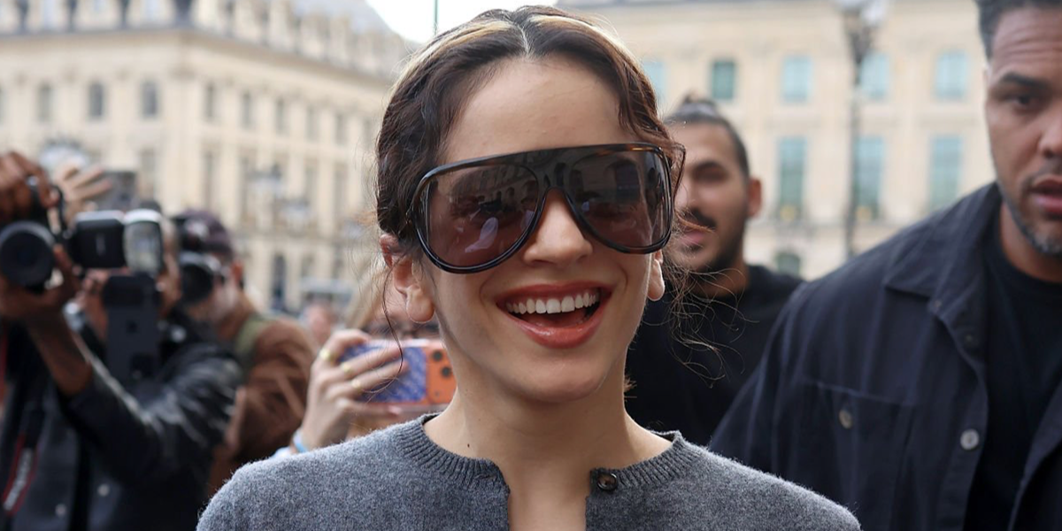 Rosalia wore tortoise Miu Miu MU A01S 11Z06I shield sunglasses with brown purple lenses during Paris Fashion Week Spring Summer 2027.