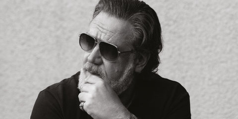 Russell Crowe was seen wearing Cutler and Gross Sun Sloane 1423 03 Silver Gold sunglasses with green gradient lenses in a The Rake feature, January 2026.