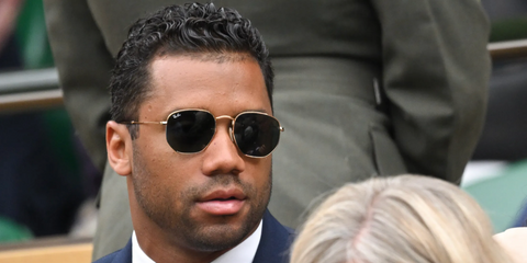 Russell Wilson is seen wearing Ray-Ban RB 3548N 001 Hexagonal Gold With Flat Lenses sunglasses to the Wimbledon