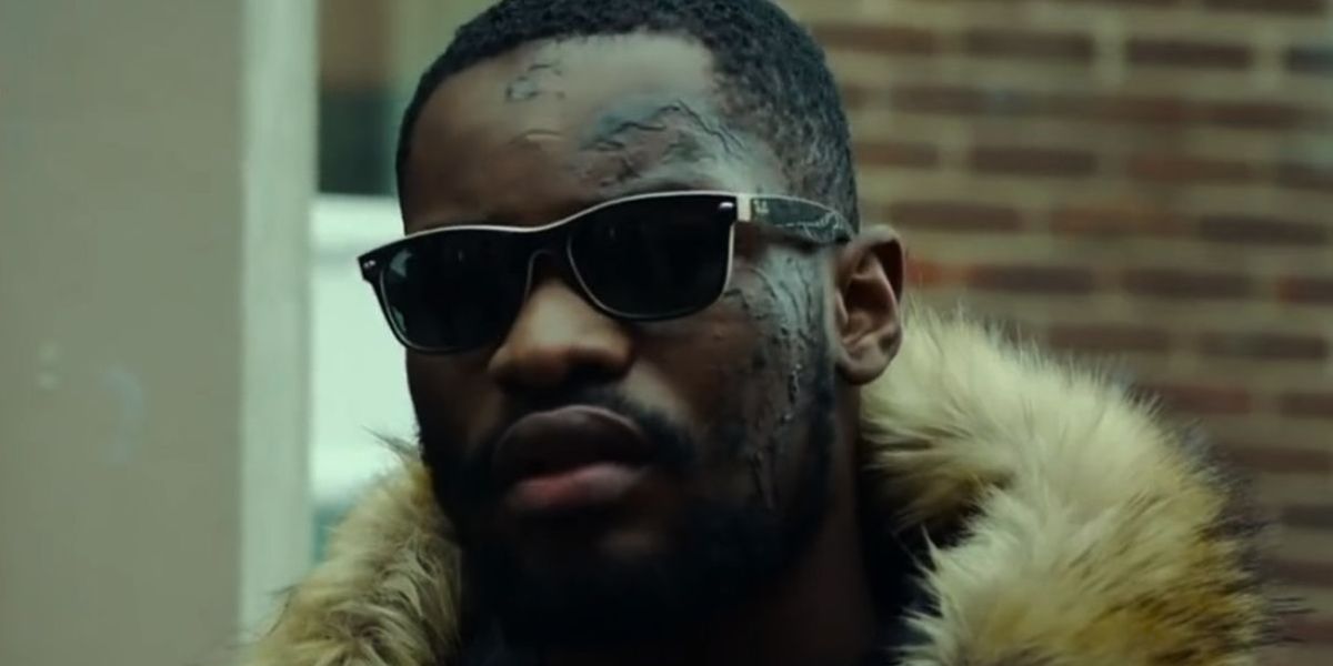 Rapper Santan Dave was seen wearing black and beige Ray-Ban New Wayfarer 2132 875 Color Mix sunglasses in 2019 Netflix show Top Boy.