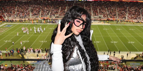 Saweetie was seen wearing Tom Ford Linden TF1094 01Y Photochromic sunglasses with pink lenses during San Francisco 49ers match at the Levi's Stadium in California