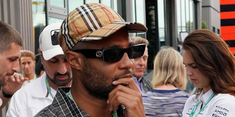 German footballer Serge Gnabry of Bayern Munich F.C. was seen wearing black Gucci GG0516S 001 sunglasses at the F1 Barcelona Grand Prix 2023.