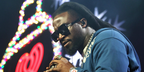 Shaboozey was seen wearing black Gucci GG0418S 001 oversized square sunglasses at iHeartRadio 102.7 KIIS FM's Jingle Ball 2024