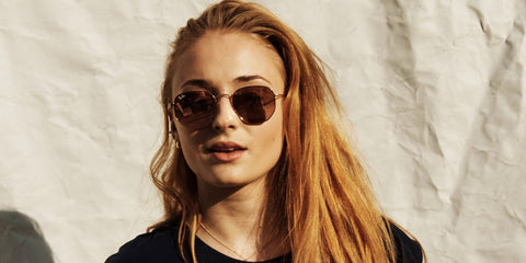 Sophie Turner was seen wearing gold Ray-Ban Hexagonal RB 3548N 9124/43 sunglasses with brown gradient lenses