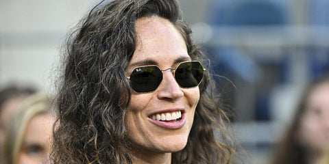 Retired basketball player Sue Bird was seen wearing gold Ray-Ban Octagonal RB 3556N 001 sunglasses at the game between the Seattle Reign and the North Carolina Courage in Seattle, August 2024. Shop online now on Pretavoir