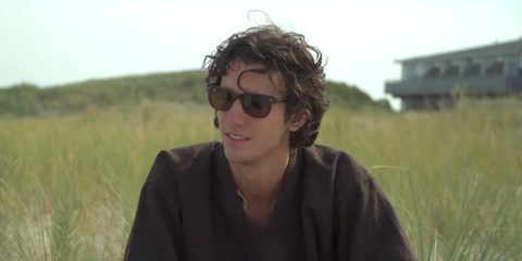 Belgian-Egyptian singer Tamino was seen wearing black Ray-Ban Wayfarer RB 2140 1294/33 sunglasses with brown lenses in an interview for Into The Great Wide Open 2022.
