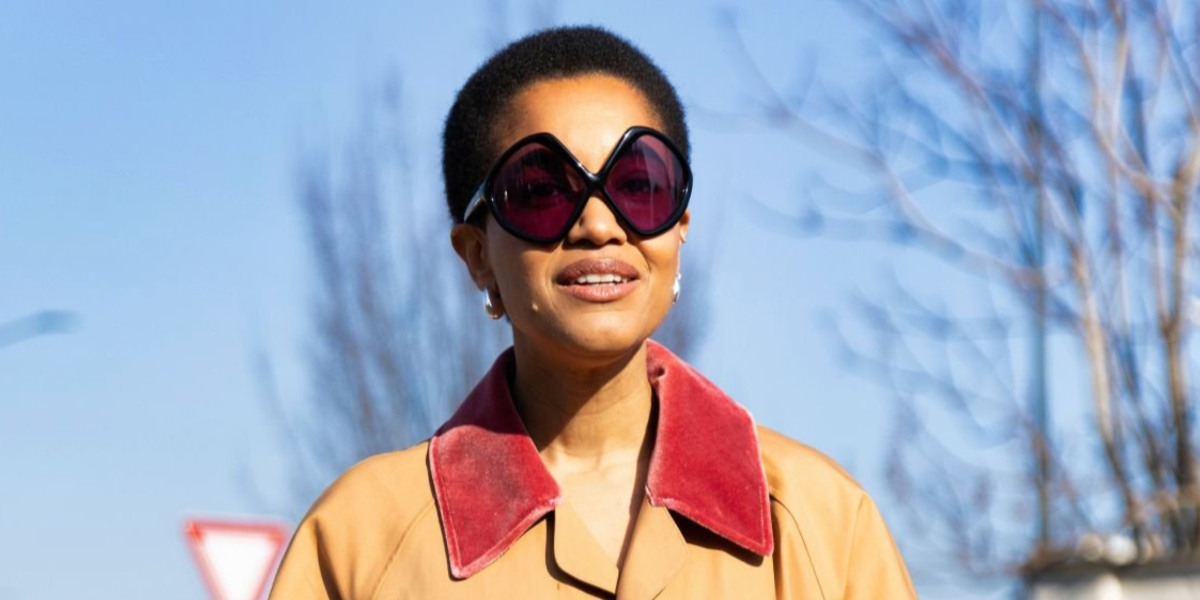 Fashion force Tamu McPherson was seen wearing black Prada PR B21S 16K30G sunglasses with purple lenses at the Prada Fall/Winter 2025 fashion show during Milan Fashion Week.