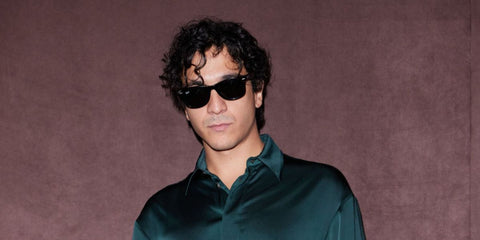 Italian singer Tananai was seen wearing the iconic Ray-Ban Wayfarer 2140 901 Black sunglasses at the Ferrari Spring/Summer 2025 fashion show during Milan Fashion Week.