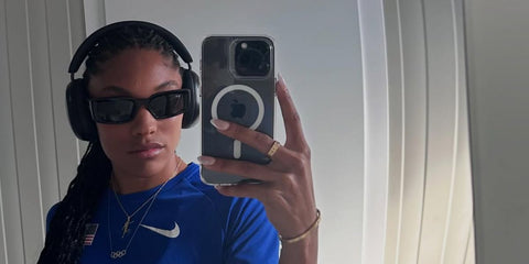 Track and field athlete Tara Davis-Woodhall was seen wearing black Ray-Ban Kiliane RB 4395 6677/87 sunglasses with grey lenses during Paris Olympics 2024.
