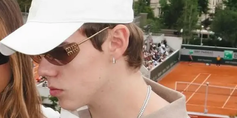 The Kid LAROI was seen wearing gold Miu Miu MU A51S 5AK20P rimless sunglasses with brown lenses at the French Open 2025.