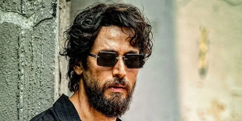 Bollywood actor Tiger Shroff was seen wearing black and ruthenium David Beckham DB 7109/S 85KIR rimless sunglasses