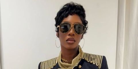 Tiwa Savage was seen wearing gold Bottega Veneta BV1305S 007 Sardine aviator sunglasses in her Instagram post, June 2026.