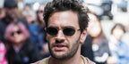 Actor Tom Bateman was seen wearing gold and black Persol Ida 1018S 515/58 Polarised oval sunglasses at the Toronto International Film Festival 2025. Shop online now on Pretavoir