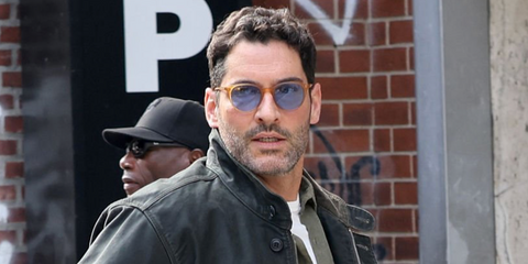 Actor Tom Ellis was seen wearing amber Oliver Peoples Riley Sun OV5004SU 1699/56 sunglasses with blue lenses on the set of C.I.A. in New York City, September 2025