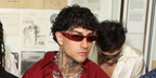 Italian rapper Tony Effe was seen wearing red Gucci GG1778S 003 sunglasses at the Gucci Menswear Spring/Summer 2025 fashion show during Milan Men's Fashion Week.