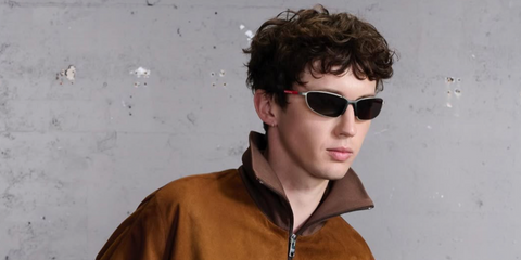 Troye Sivan was seen wearing silver grey Prada Linea Rossa SPS 55Z 18X80I sunglasses at The Sound of Prada Berlin, May 2025. Shop online now on Pretavoir