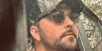 American country singer Tyler Farr was seen wearing black and transparent Ray-Ban Hawkeye RB 2298 1294/M3 Polarised sunglasses in his Instagram post, April 2023.
