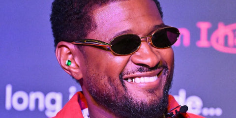 Usher was seen wearing gold Bottega Veneta Sardine BV1386S 001 sunglasses with grey lenses during the Instagram "Carversations" content series experience in Atlanta, Georgia, December 2025.