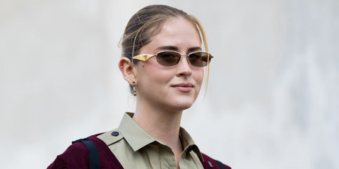 Italian influencer and entrepreneur Valentina Ferragni was seen wearing gold Prada PR D51S 5AK20I sunglasses at the Prada Fall/Winter 2026 fashion show during Milan Fashion Week.