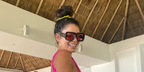 Vanessa Hudgens was seen wearing black Loewe x Paula's Ibiza LW40064U 01Y sunglasses with red lenses in her Instagram post, December 2025.