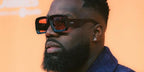 Ferench rapper and singer was seen wearing black Loewe x Paula's Ibiza LW40064U 01Y sunglasses with red lenses in his Instagram post, May 2024