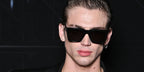 Model and content creator Vinnie Hacker was seen wearing black Saint Laurent Sun SL 610 001 square sunglasses at the Saint Laurent Spring/Summer 2024 fashion show during Paris Fashion Week.