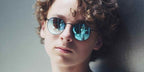 Wyatt Oleff was seen wearing black Ray-Ban Round Metal RB 3447 002/4O sunglasses with brown gradient and light blue mirror lenses