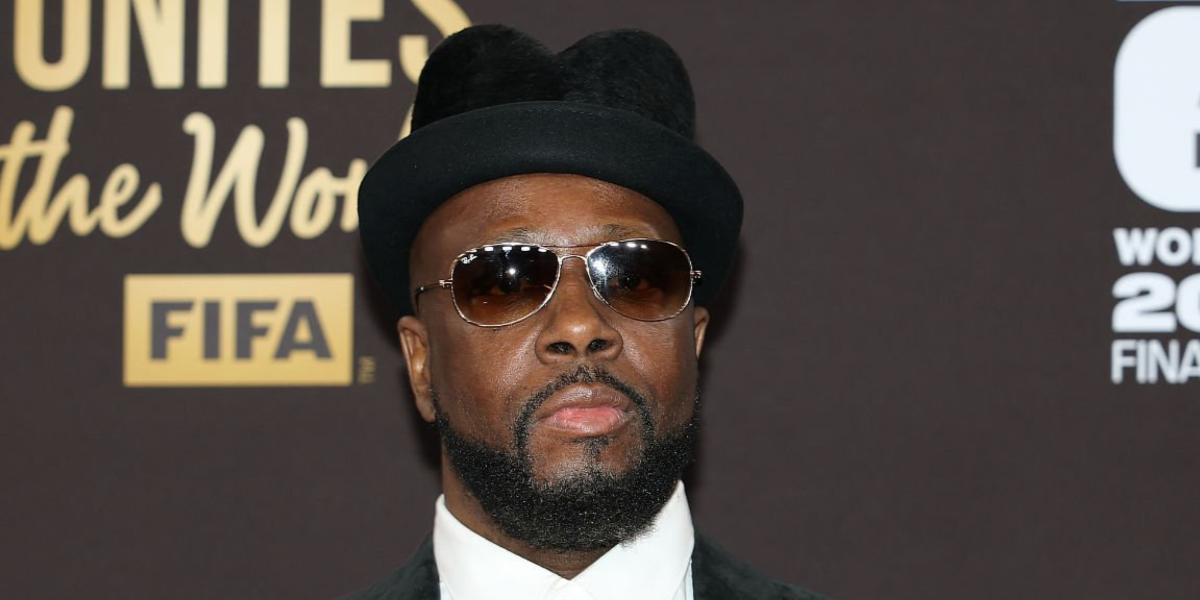 Wyclef Jean was seen wearing gold Ray-Ban Cockpit 3362 001/51 sunglasses with brown gradient lenses at the FIFA World Cup 2026 Official Drawing in Washington DC, December 2025