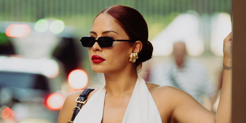 Influencer and beauty entrepreneur Yris Palmer was seen wearing black Miu Miu Regard MU 11ZS 16K5S0 rectangular sunglasses in Paris, shared through her Facebook post in June 2024.