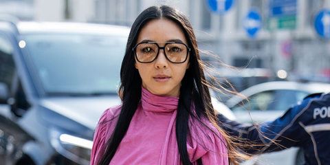 Chinese fashion influencer Yuwei Zhangzou was seen wearing black Saint Laurent SL 545 001 aviator sunglasses with light yellow lenses at the Gucci Fall/Winter 2026 fashion show during Milan Fashion Week.