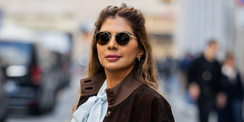 Dubai-based influencer and accessories designer Zufi Alexander was seen wearing gold Miu Miu MU 55ZS 5AK09Z round sunglasses during Milan Fashion Week season Fall/Winter 2026.