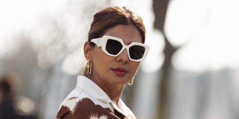 Dubai-based influencer and accessories designer Zufi Alexander was seen wearing white Prada PR 14ZS 1425S0 sunglasses at the Prada Fall/Winter 2026 fashion show during Milan Fashion Week.